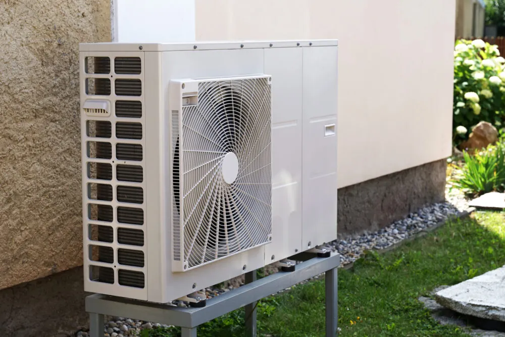 Heat pump outdoors next to a house