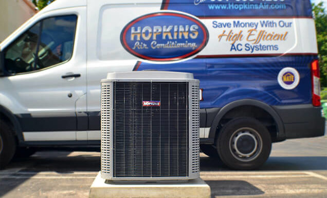 Hopkins Air Conditioning service truck behind a new AC unit.
