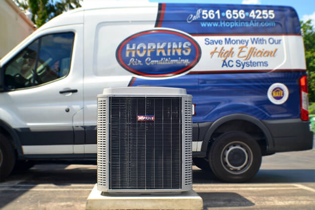 Hopkins brand air conditioning unit in front of a Hopkins service truck.