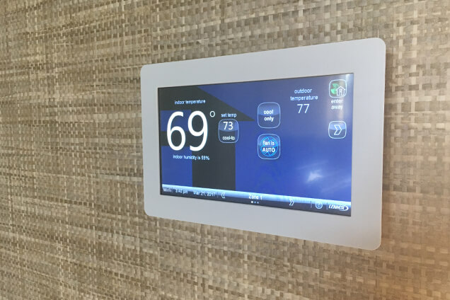 A smart thermostat on a home's wall