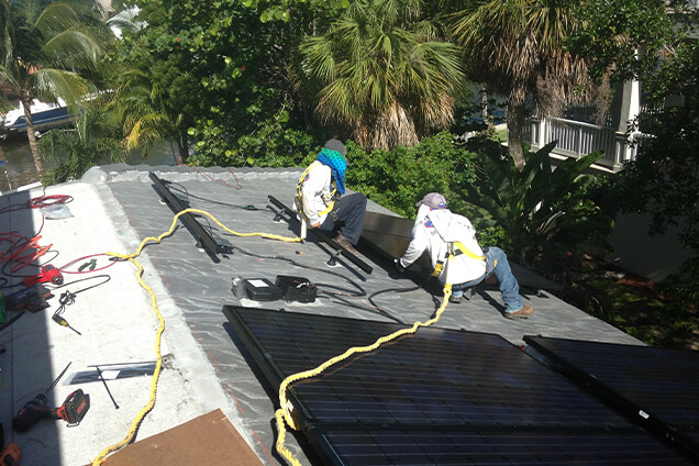 Hopkins technicians installing solar panels on West Palm Beach home