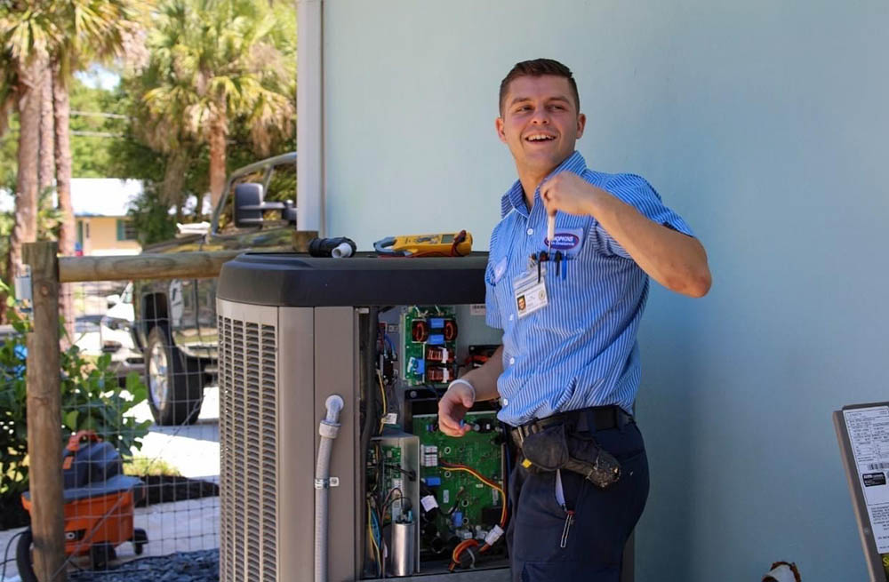 Hopkins Air Conditioning repair technician working on an outdoor AC unit.