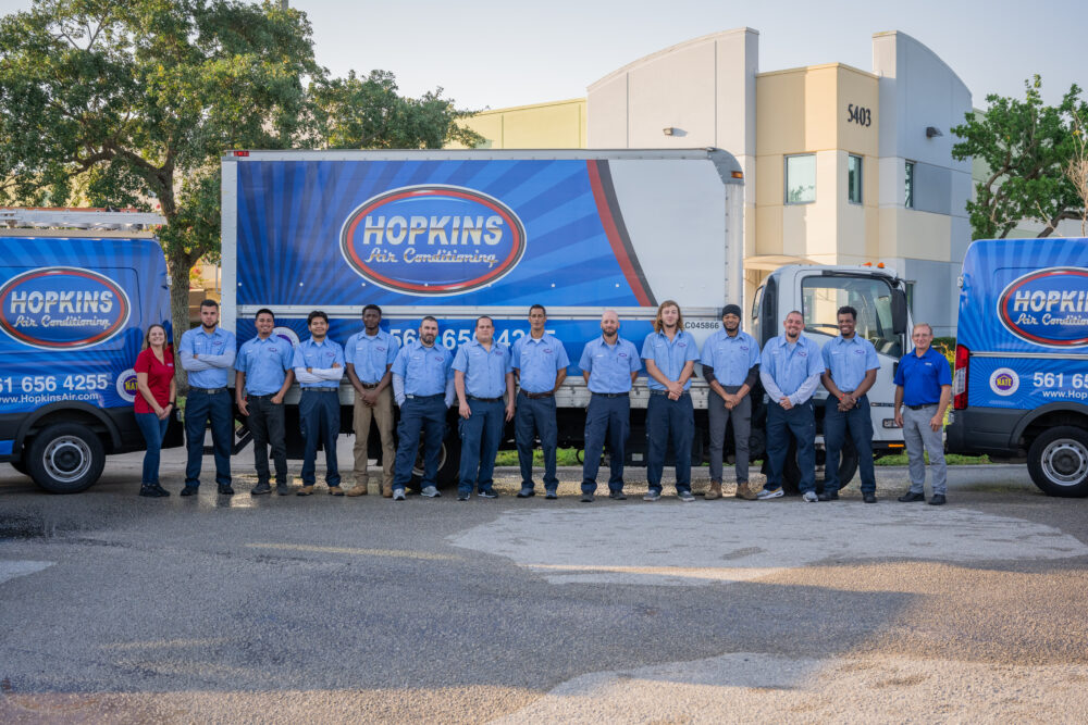 Hopkins AC team standing in front of their trucks