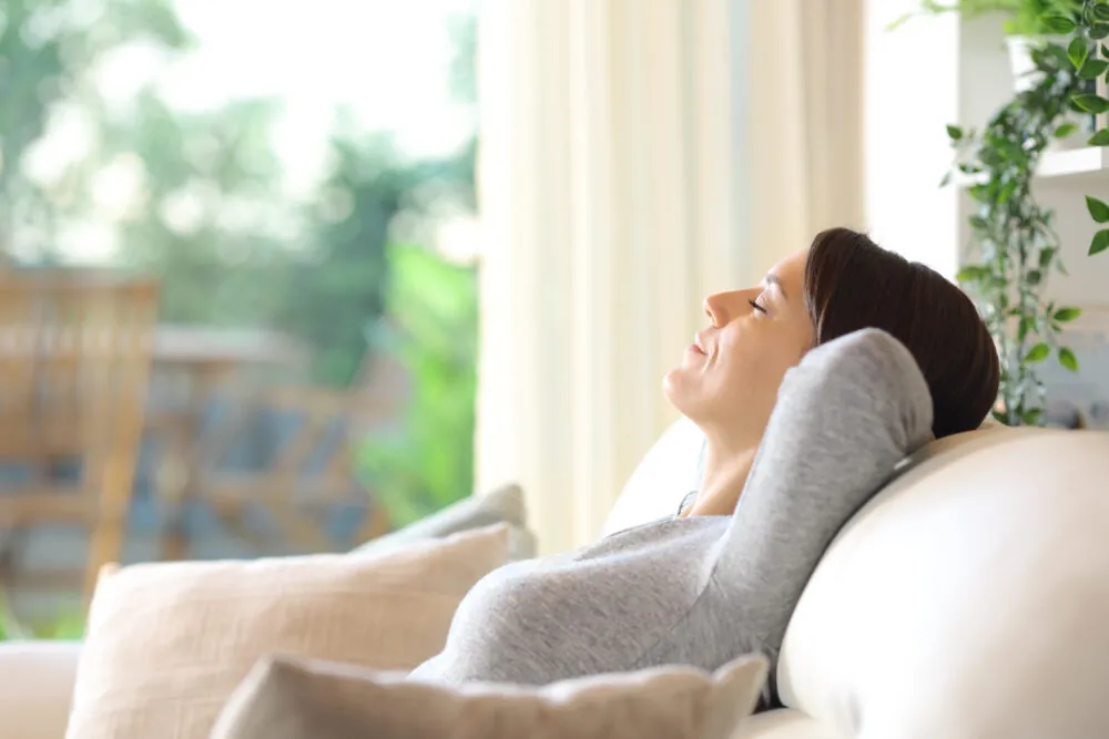 Woman relaxing on a couch alone at home