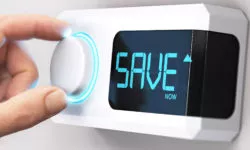 Hand adjusting a thermostat dial